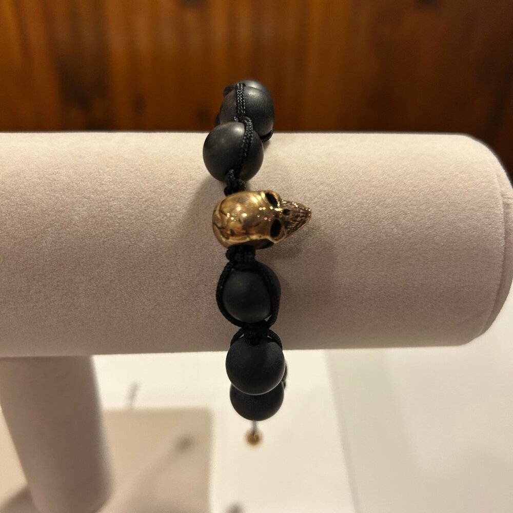 Gold skull bracelet.